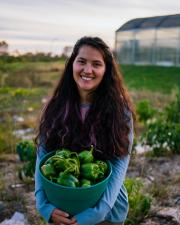 Photo of Dorothea Summers holding a bucket of produce