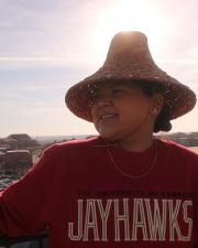 MK Kerron standing on a patio in a Jayhawks tshirt